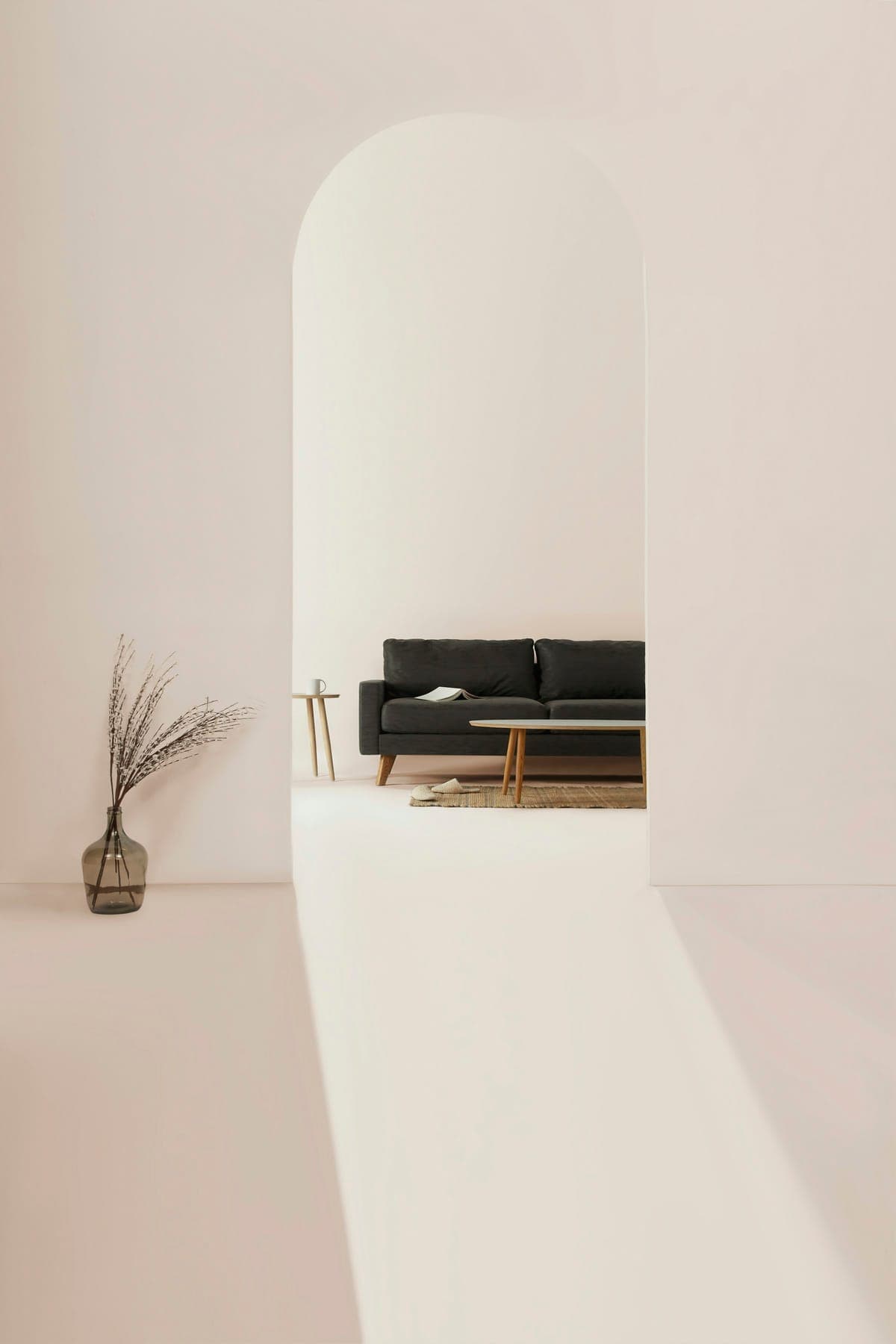 Pale plaster room seen through an arched opening.